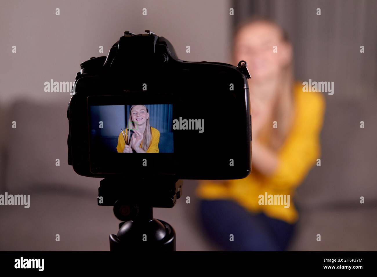 video lesson recording on a professional video camera. woman professional makeup artist broadcasts Stock Photo