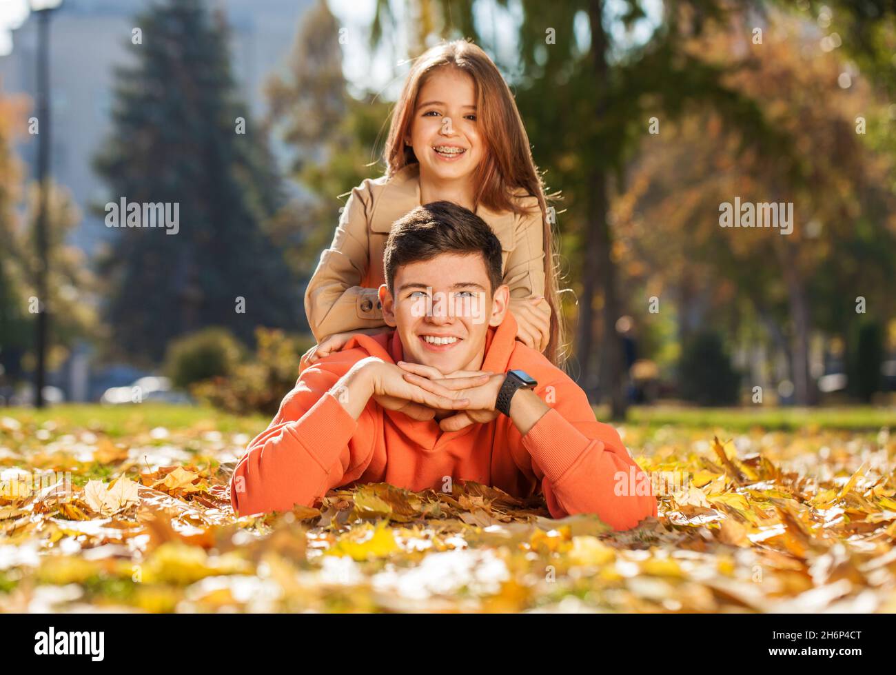 Happy teenager brother and sister in the autumn park Stock Photo - Alamy
