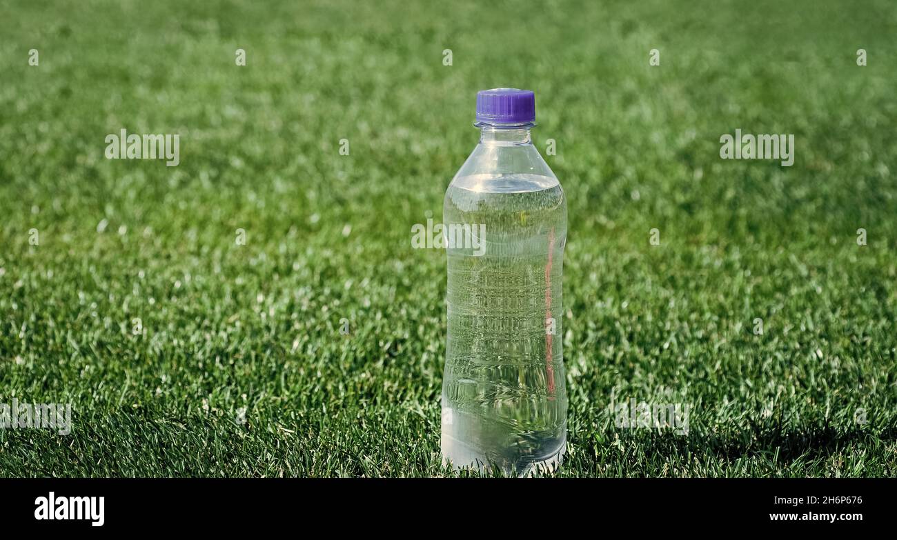 water bottle on green grass for hydration, thirst Stock Photo - Alamy