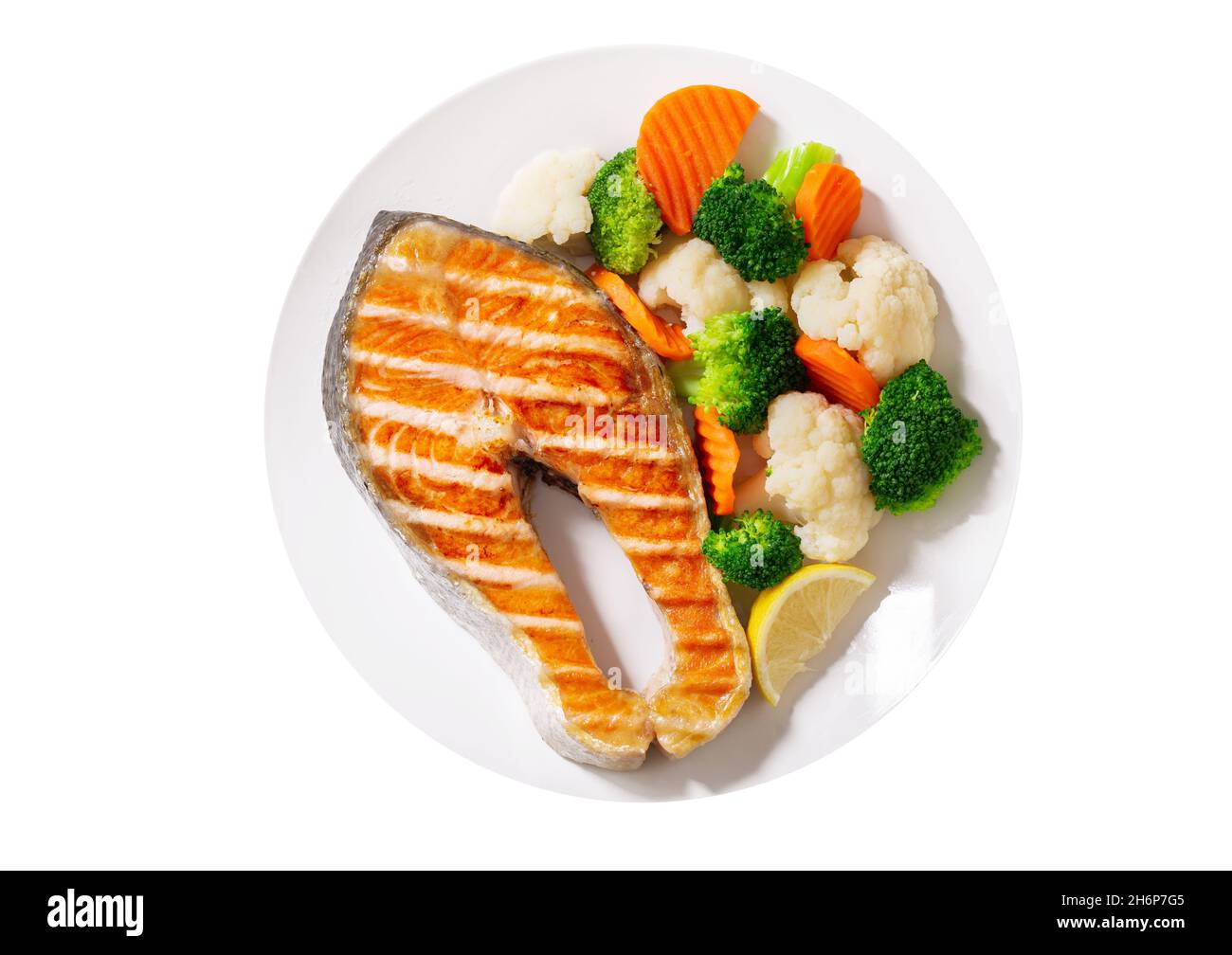 plate of grilled salmon steak with vegetables isolated on white ...