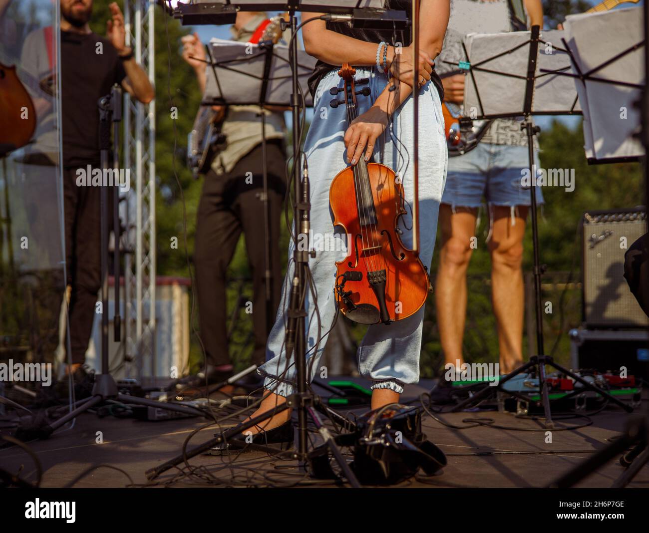 Female violinist standing near music stand outdoors Stock Photo