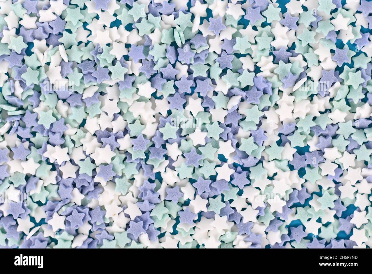 Star shaped sugar sprinkles with blue, teal and white color Stock Photo