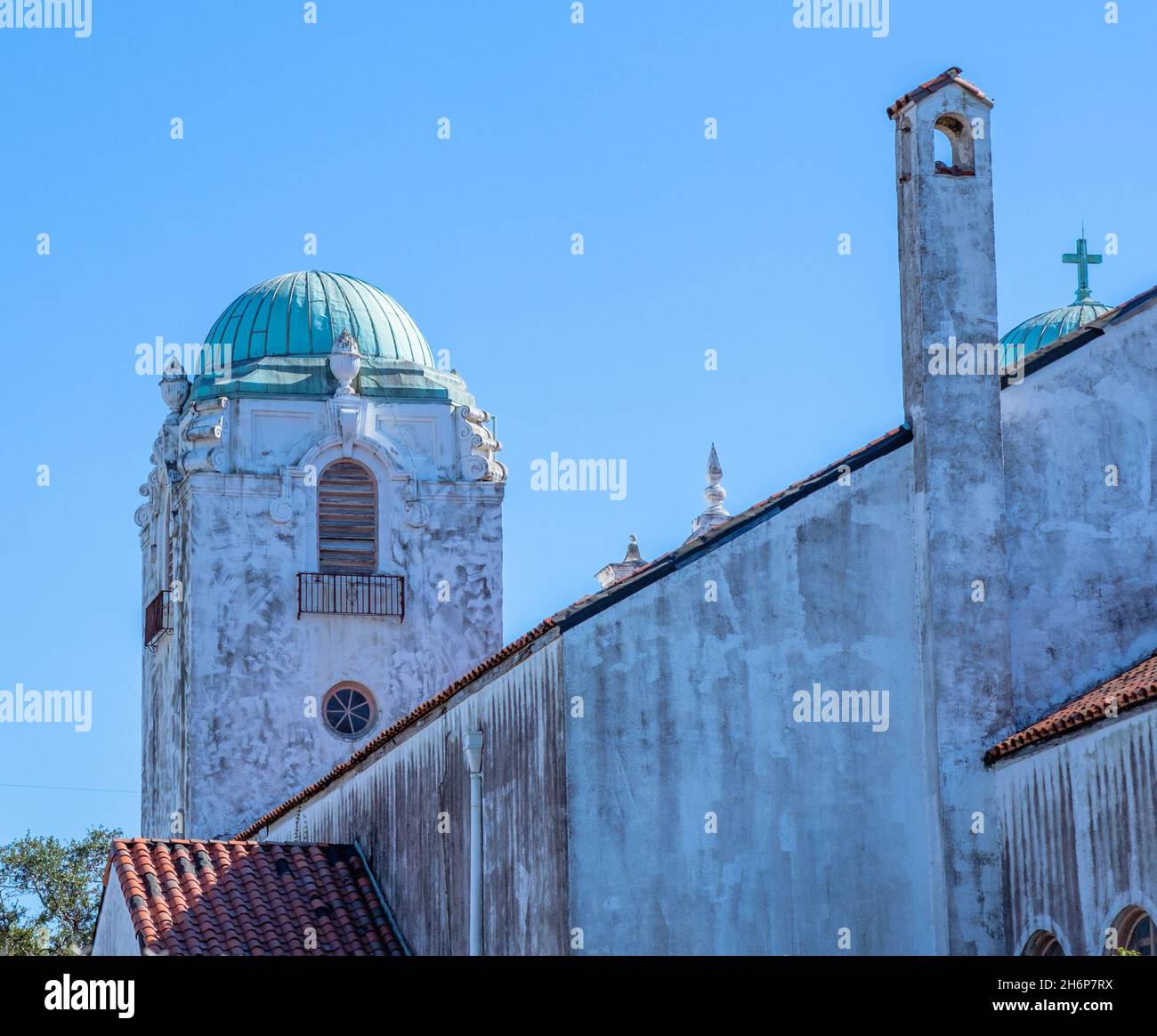 NEW ORLEANS, LA, USA - NOVEMBER 13, 2021: Towers and tiled roof of Our Lady of Lourdes Catholic Church on Napoleon Avenue Stock Photo