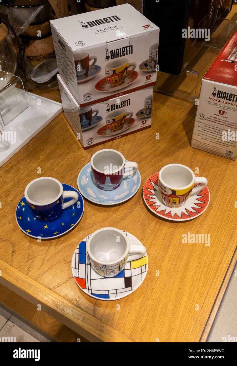 Four small espresso cups and saucers for sale in a store Stock Photo