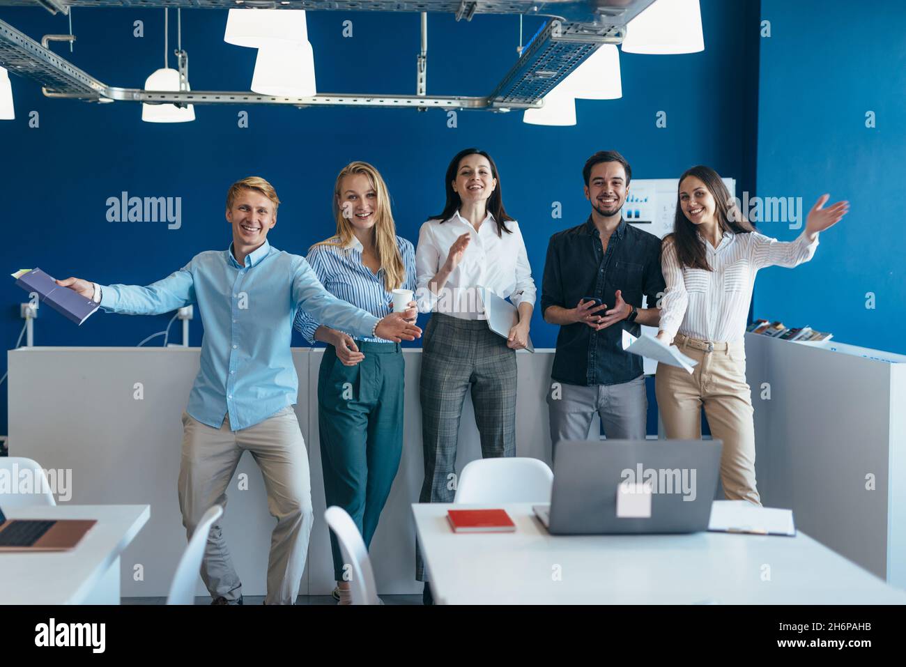 Group of joyful young people welcoming with open arms Stock Photo - Alamy