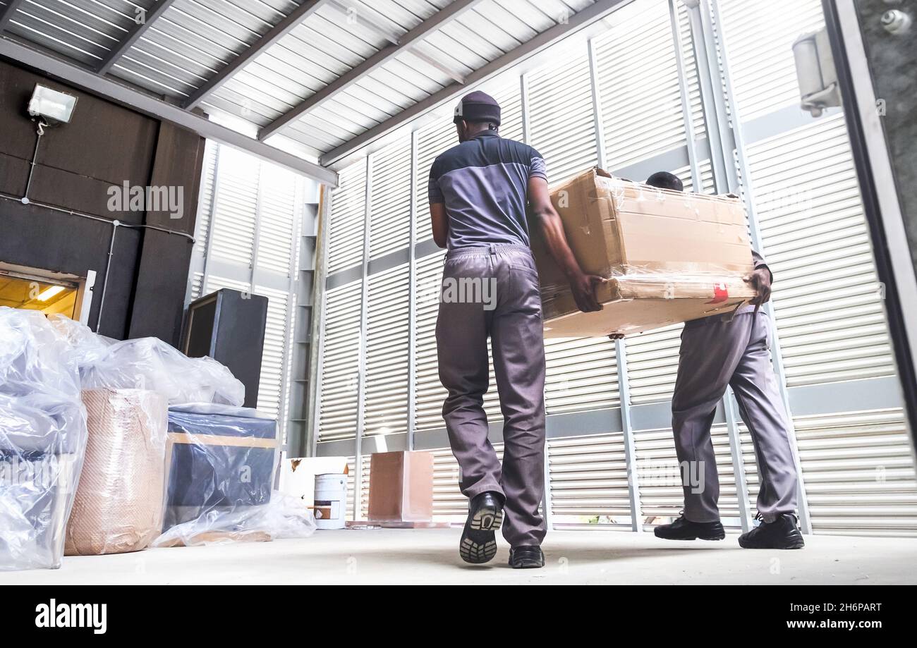Men delivering boxes from a truck. Furniture delivery Stock Photo Alamy