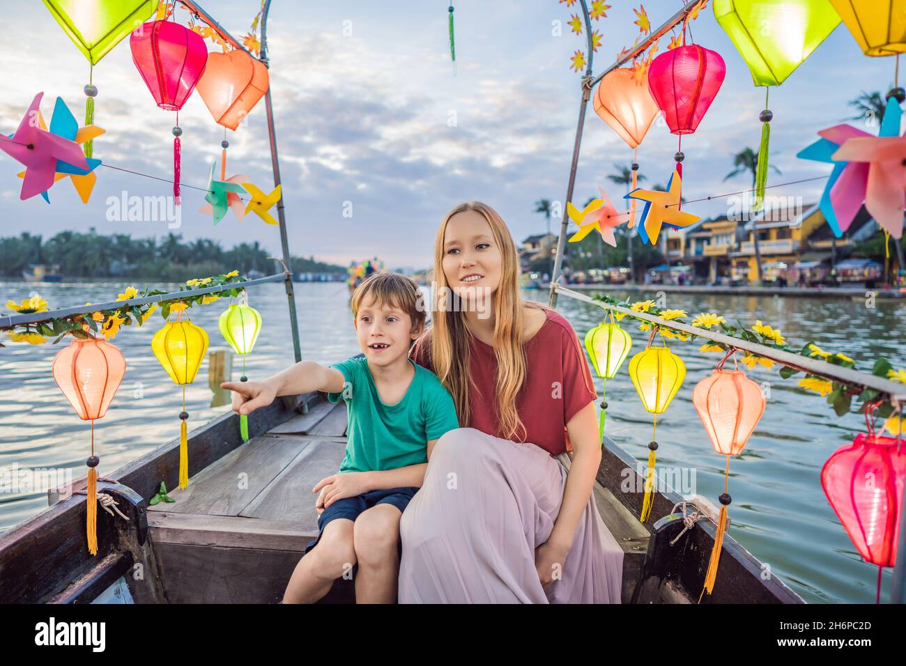 Happy family Mother and son of travelers ride a national boat on ...