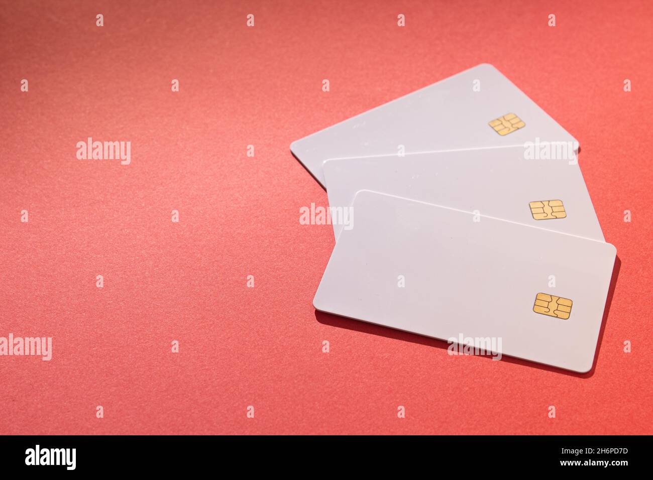 Closeup of the white cards with a chip on a red background Stock Photo ...
