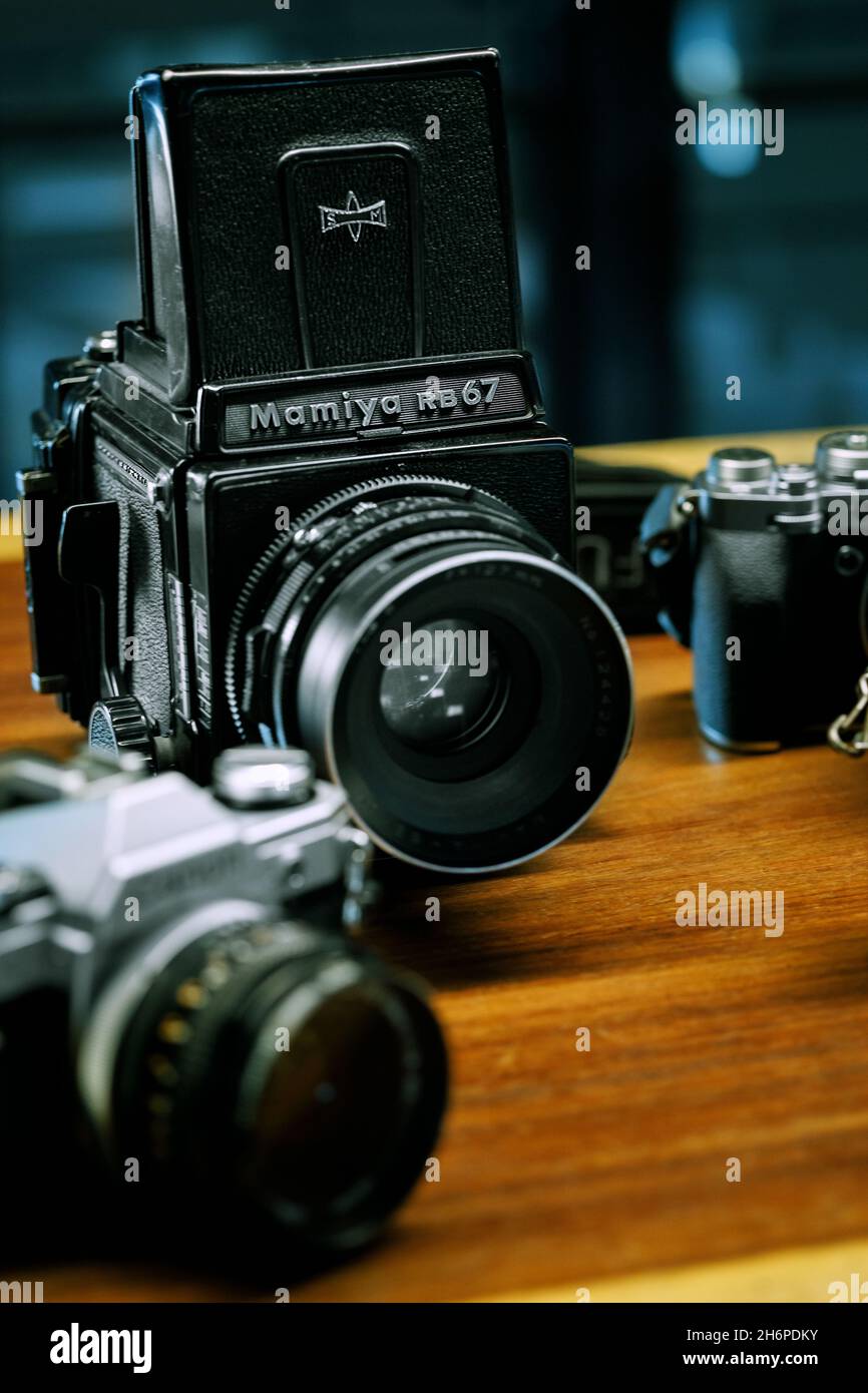 Izmir, Turkey - July 9, 2021: Illustrative editorial Close up shot of Mamiya RB67 medium format analog film camera and other cameras defocused on the Stock Photo