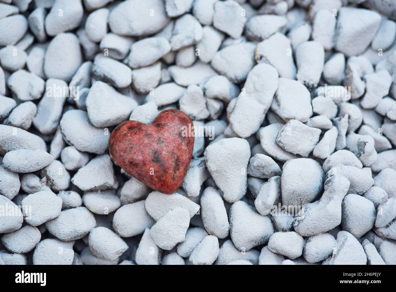 A carved / sculpted heart from a piece of granite stone on a background ...