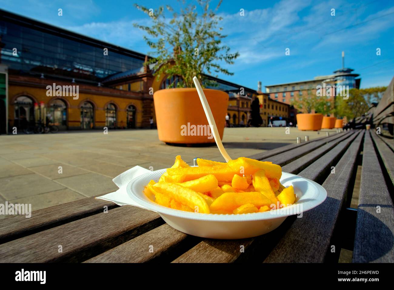 Plate of crisps ready to eat outdoors in town square Stock Photo