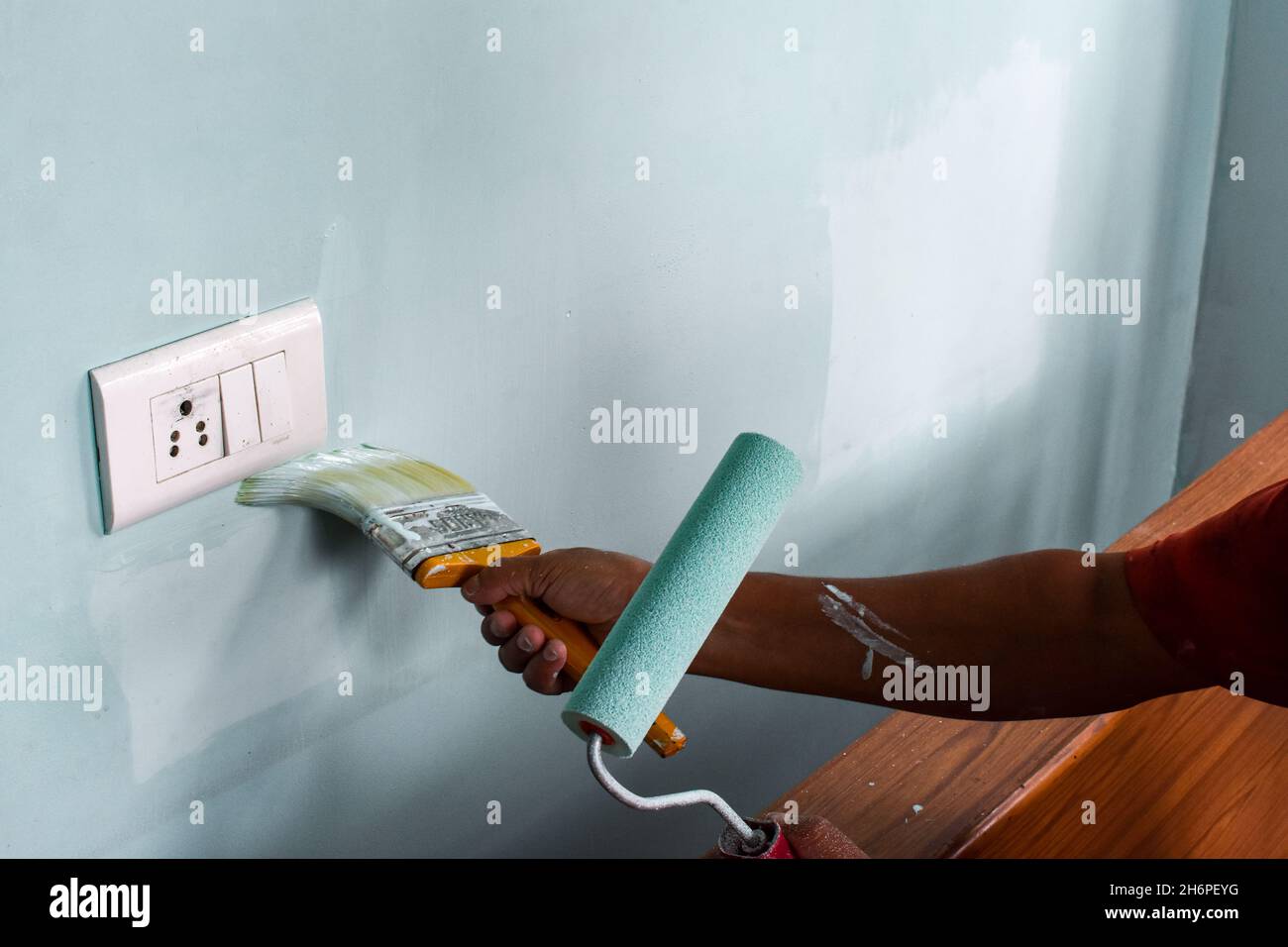 Hand painting wall with roll and brush Stock Photo Alamy