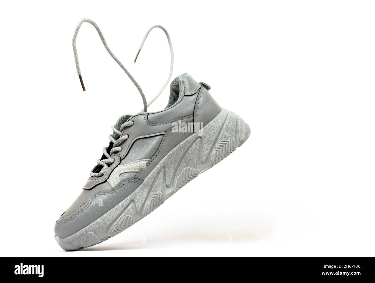 Beige women's sneakers on a white background. Levitating sneaker with flying laces Stock Photo ...