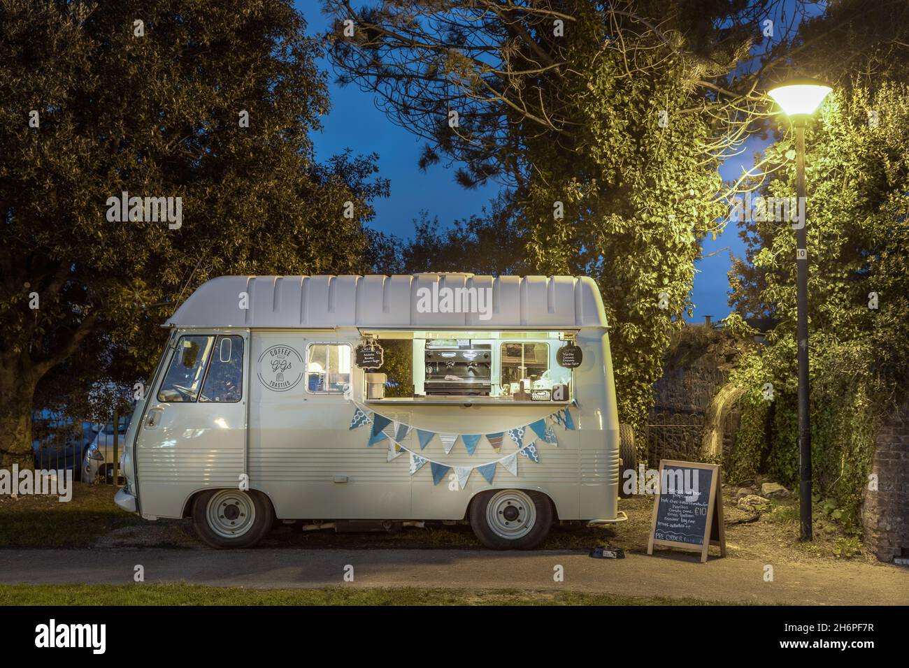 Passage, Cork, Ireland. 16th November, 2021. A classic 1976 peugeot j7 campervan which has now been converted as a mobile coffee shop at the seafront in late evening at Passage, Co. Cork, Ireland. - Picture; David Creedon / Alamy Live News Stock Photo