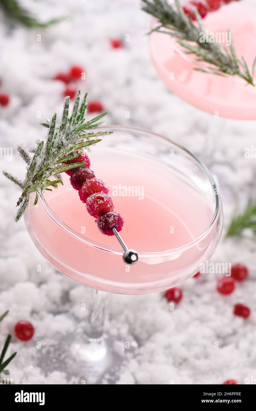Goblet with cranberry Margarita with candied cranberries, rosemary. Perfect cocktail for a Christmas party Stock Photo