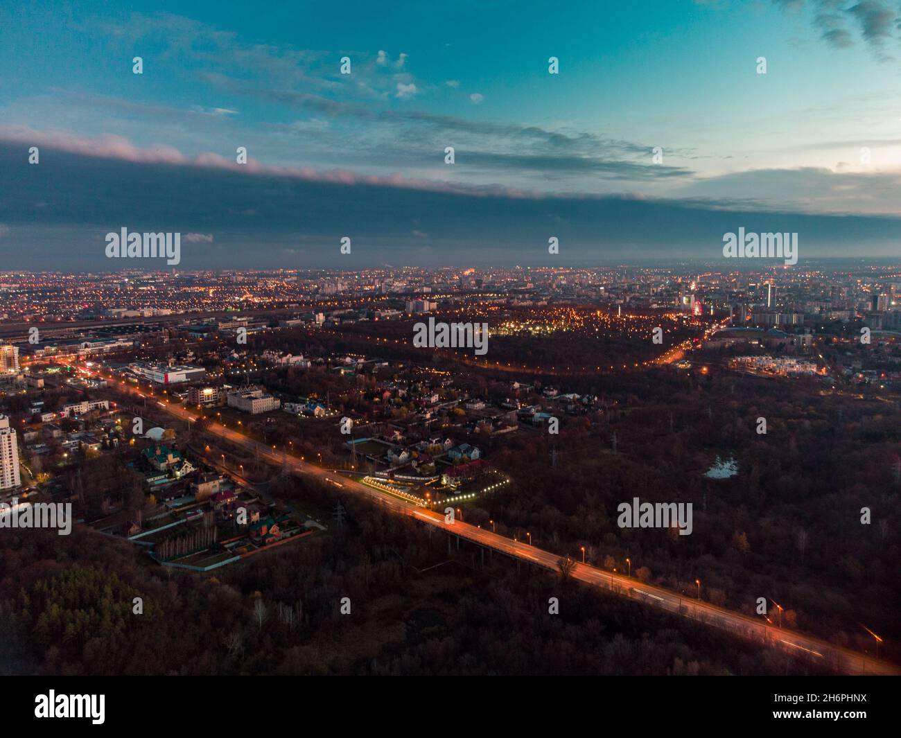 Aerial evening view on Kharkiv city center streets with night lights near recreation park Sarzhyn Yar. Residential district, scenic sunset view with e Stock Photo