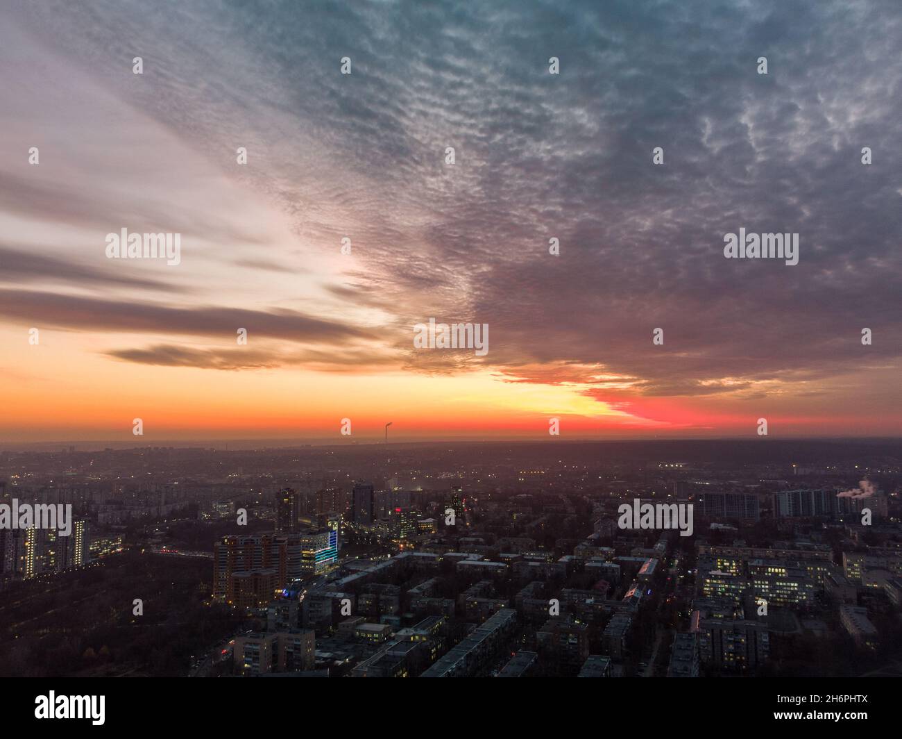 Aerial scenic vivid colorful sunset panoramic view with epic skyscape. Kharkiv city center, Pavlove pole residential district streets and buildings in Stock Photo