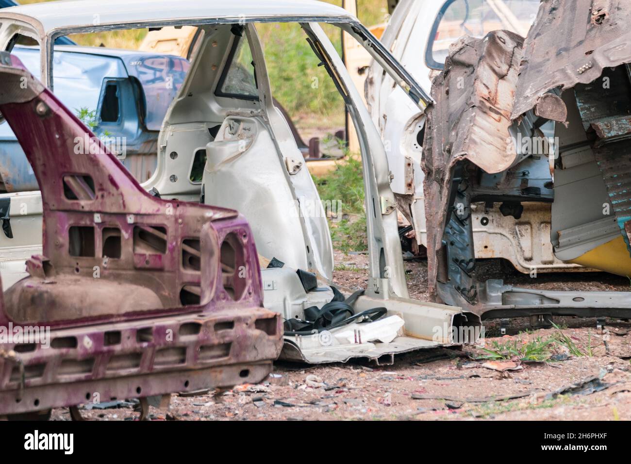Metal broken cars body parts abandoned outdoors. Car dump, wreck at a junkyard ready for