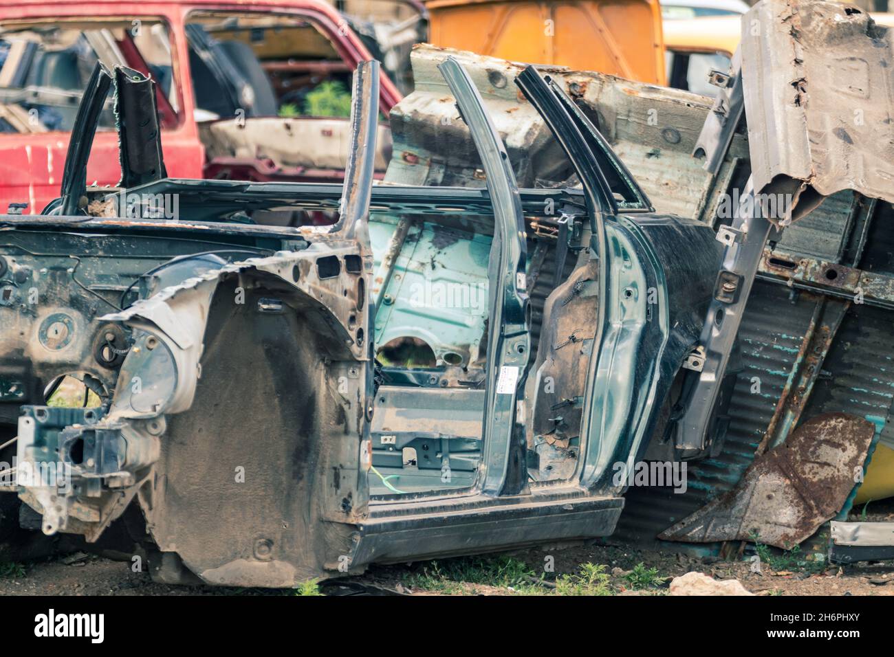 Metal rusty car body parts abandoned. Car dump, wreck at a junkyard
