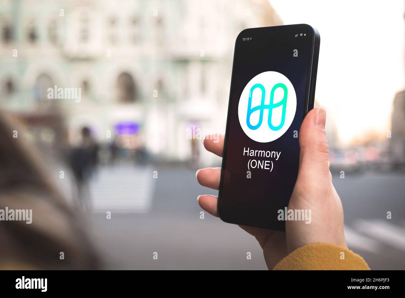 Harmony ONE cryptocurrency symbol, logo. Business and financial concept.  Hand with smartphone, screen with crypto icon closeup Stock Photo - Alamy