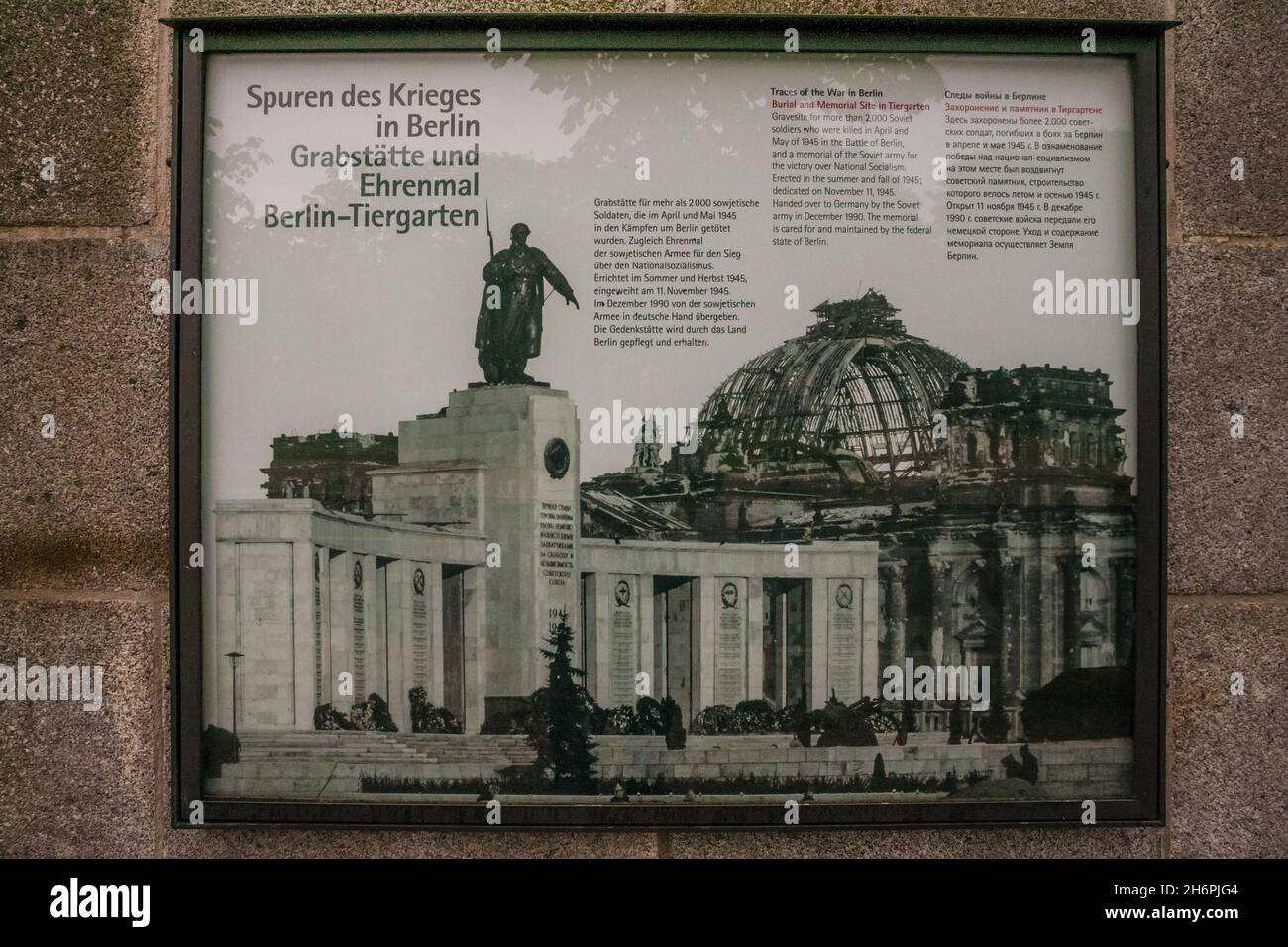 Close-up of a historic marker at the Soviet War Memorial in the park Tiergarten in Berlin, showing a photograph of the Soviet memorial with the ruins... Stock Photo