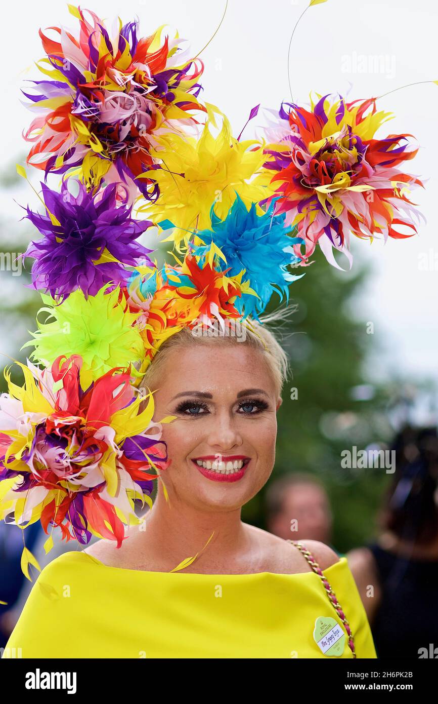Pretty woman impresses with a glamorous floral hat before she attends Royal Ascot Stock Photo