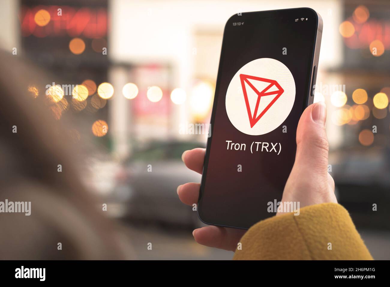 Tron TRX cryptocurrency symbol, logo. Business and financial concept. Hand  with smartphone, screen with crypto icon closeup Stock Photo - Alamy