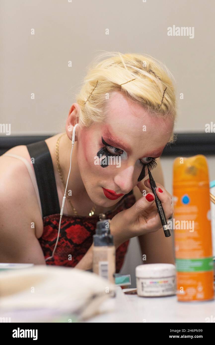 Male drag queen applying make-up before a show. Stock Photo