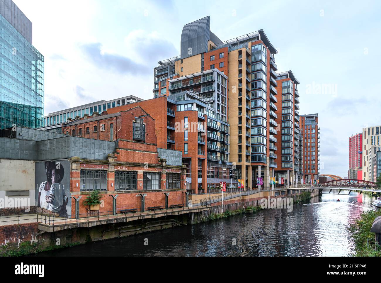 Spinningfields, Manchester. Smart new apartment buildings on the River Irwell. The Peterloo mural by Axel Void is at the People's History Museum. Stock Photo