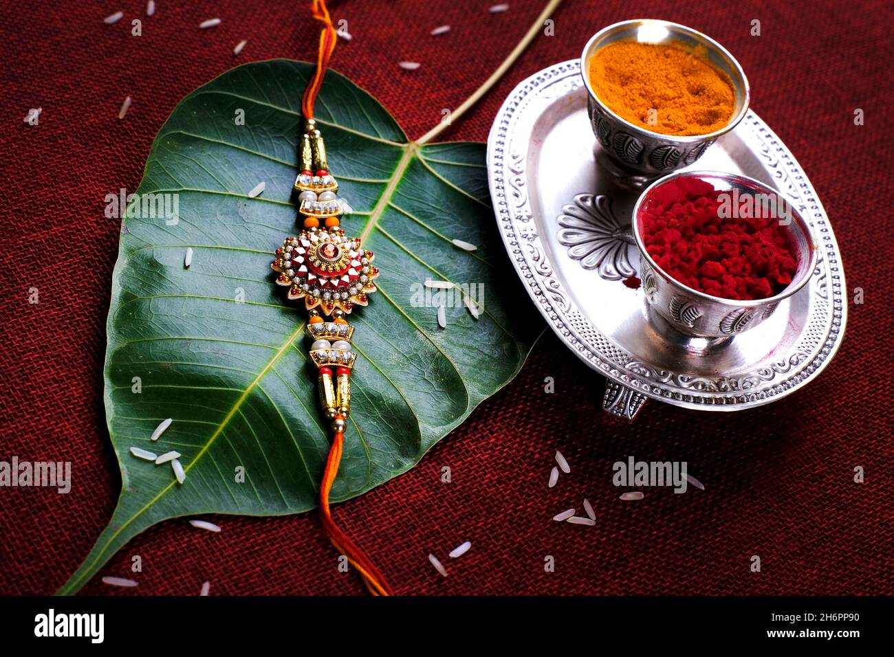 Indian festival: Raksha bandhan Raakhi with sweets gifts flowers and diya, Raksha Bandhan (Bond of protection and care). Stock Photo