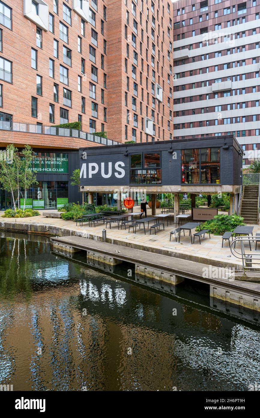Kampus modern apartment complex running alongside the Rochdale Canal, with a popular bar and cafe with outside seating. Stock Photo