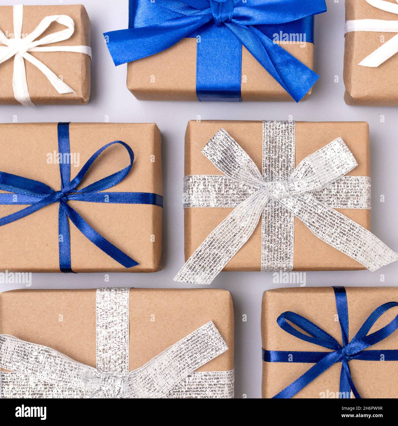 Gifts Using Ribbon Gifts tied with ribbons on a blue background. Festive creative layout ...