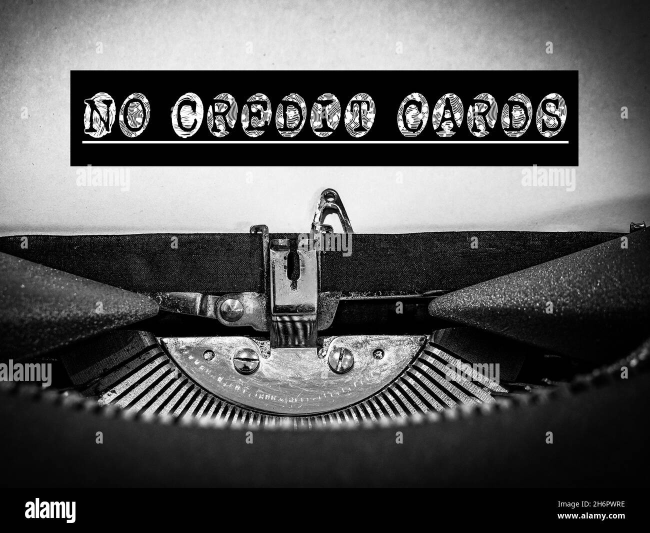 NO CREDIT CARDS displayed on a classic vintage mechanical typewriter with a black border around the text and a white underline in a B&W tone Stock Photo