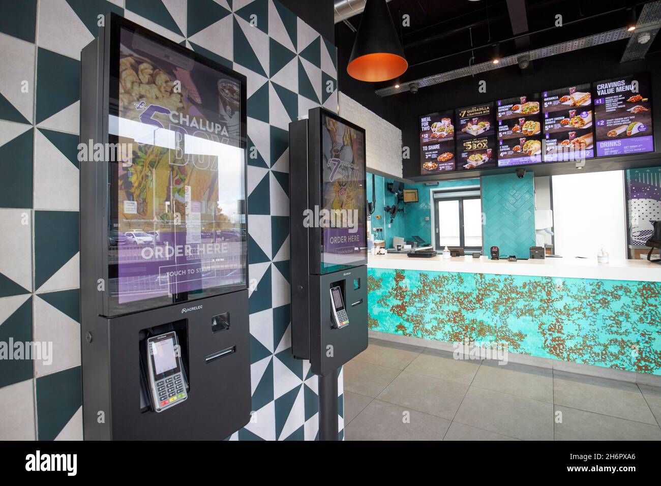 automatich touch screen ordering stations and empty customer counter taco bell kirkby Liverpool merseyside uk Stock Photo