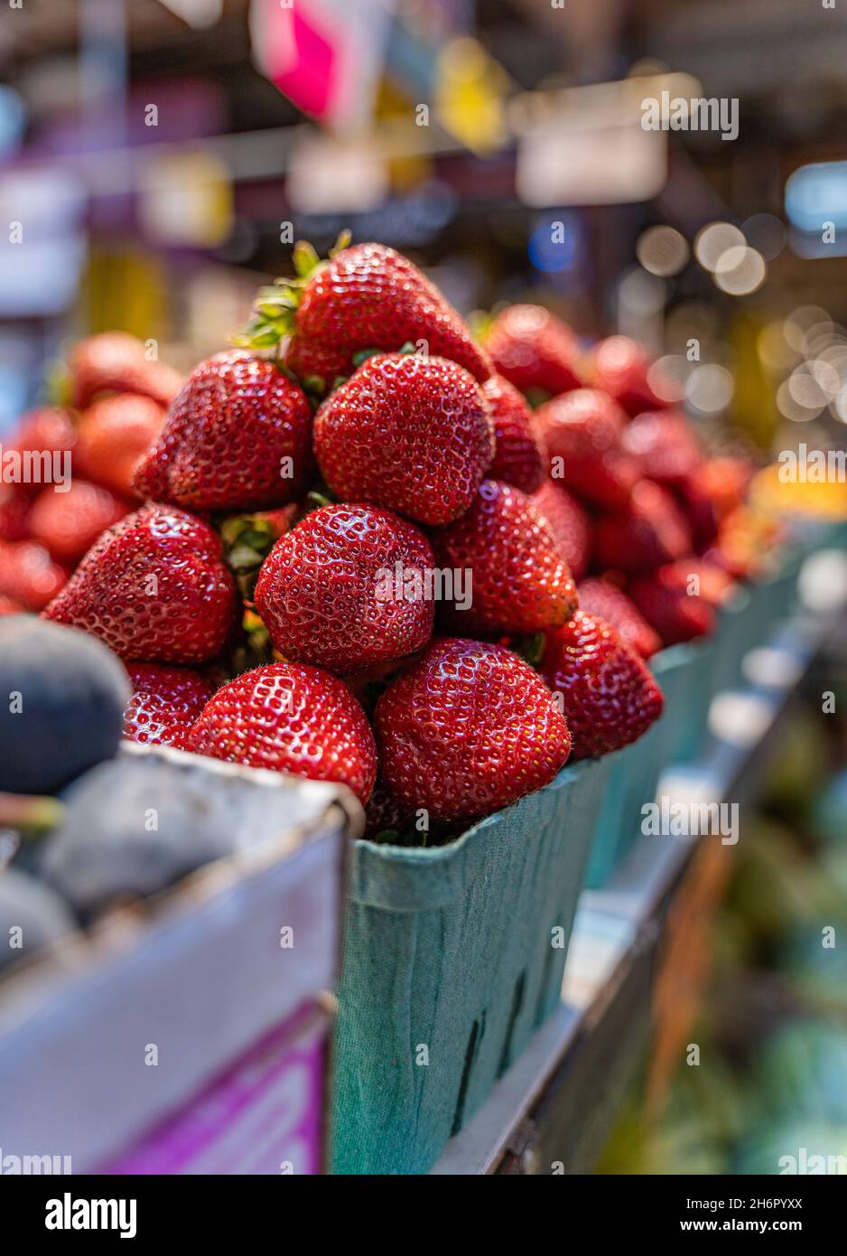 Vertical closeup shot of a bunch of giant delicious strawberries at a market Stock Photo