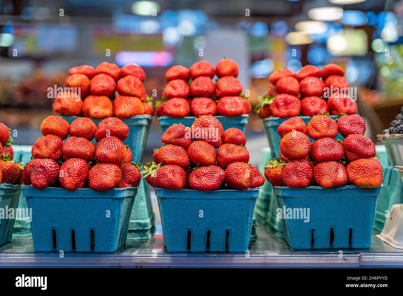 Market shelf with six boxes full of giant delicious strawberries on display for sale Stock Photo