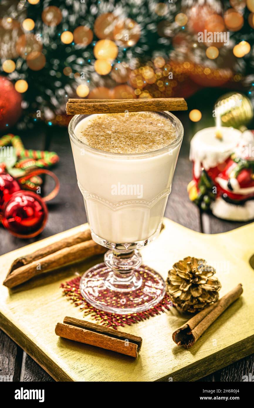 glass of hot eggnog, Christmas drink, based on eggs, cinnamon, almonds and rum liqueur. called
