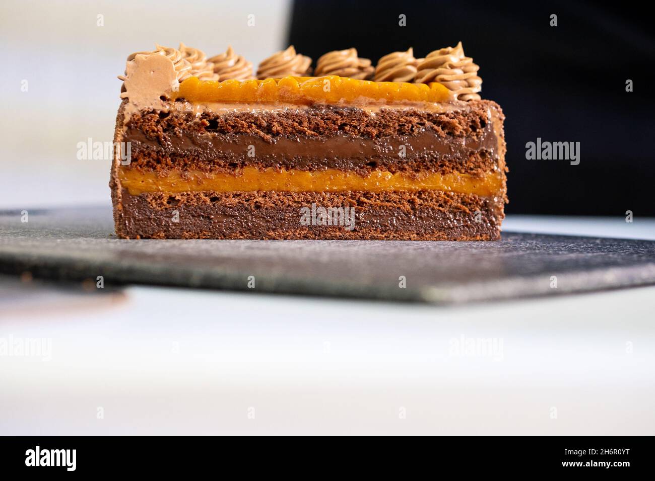 Delicious piece of cake on black plate. Stock Photo