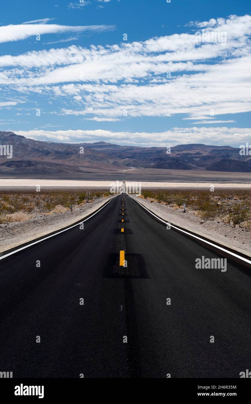 Perspective of straight highway heading towards horizon in the Panamint Valley in Death Valley National Park Stock Photo