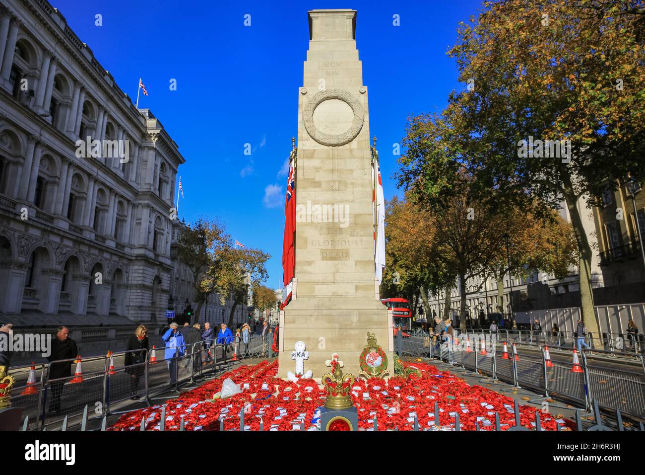 London, UK. 17th Nov, 2021. The cenotaph is seen in beautiful warm sunshine in Westminster today, following the Remembrance Sunday service. People walk around the monument on Whitehall to pay their respects and look at the wreaths that were laid. Credit: Imageplotter/Alamy Live News Stock Photo