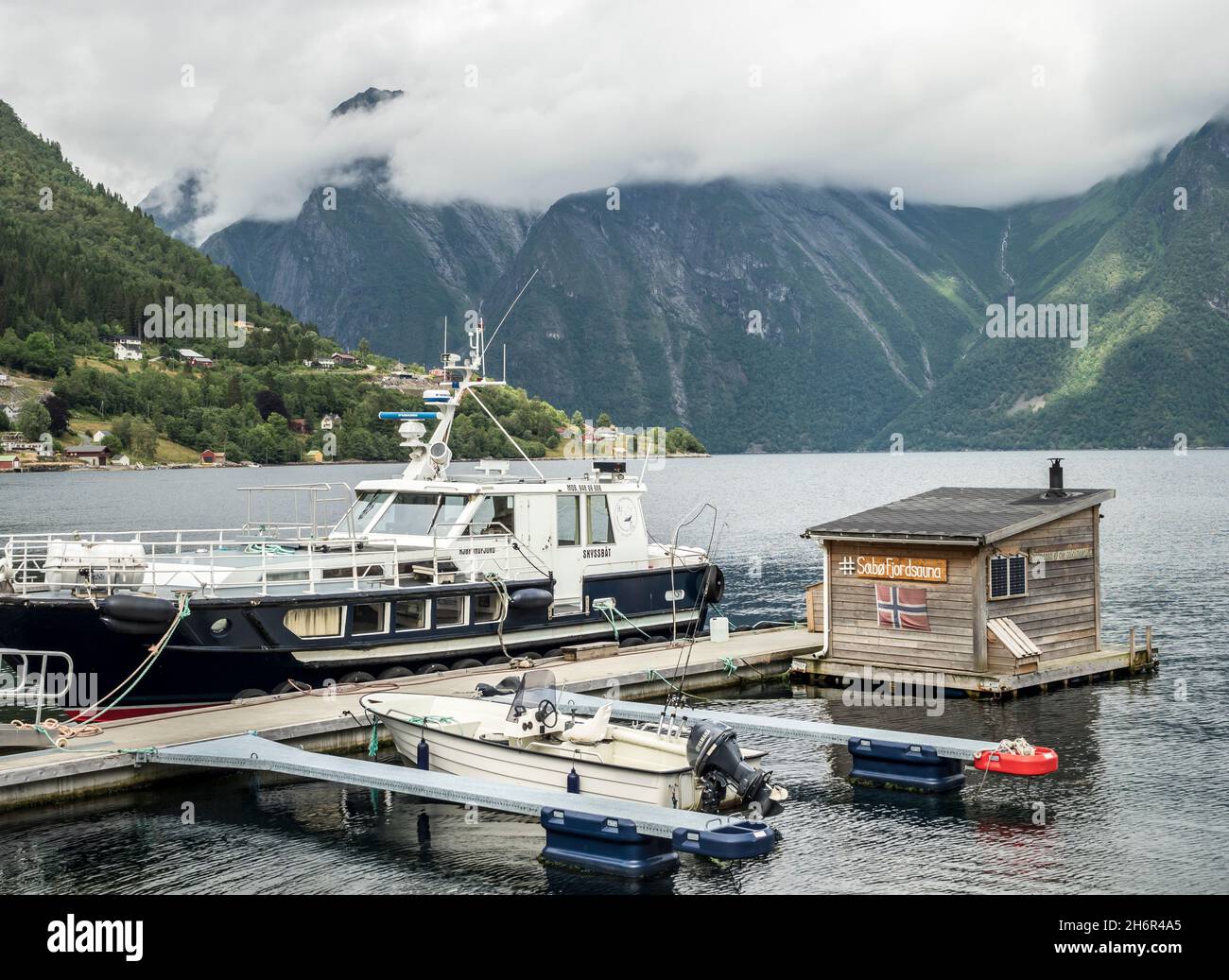 Boats and floating sauna, marina of village Saebo at the Hjorundfjord, Norway Stock Photo