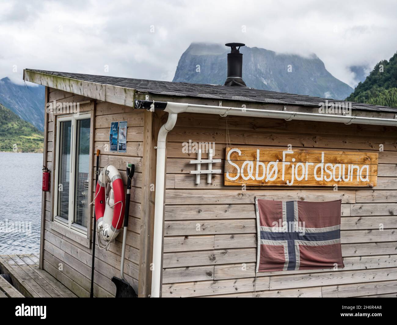 Floating sauna, marina of village Saebo at the Hjorundfjord, Norway Stock Photo