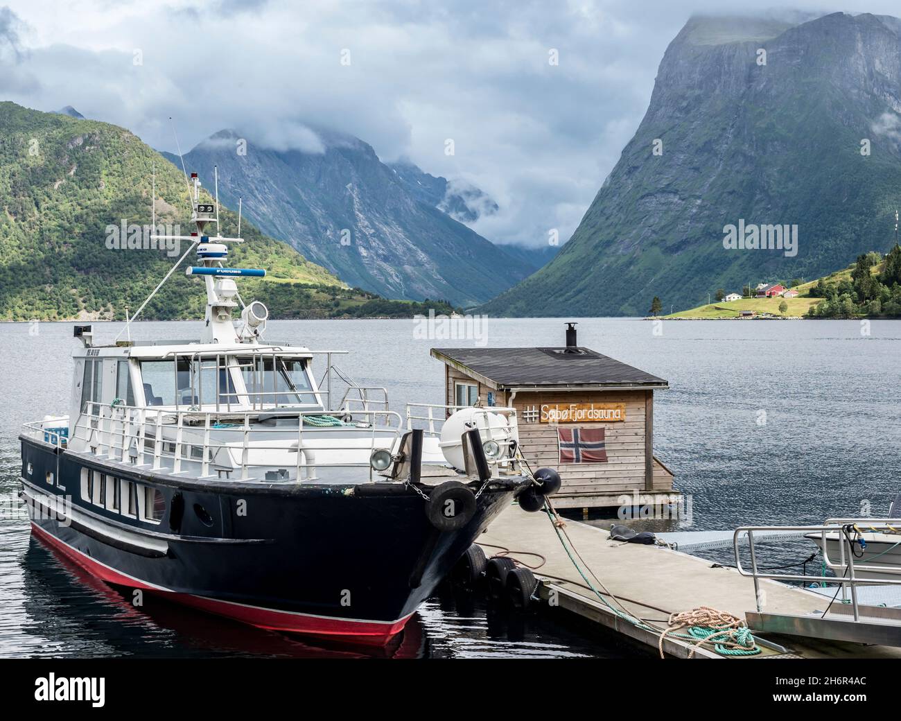 Boats and floating sauna, marina of village Saebo at the Hjorundfjord, Norway Stock Photo