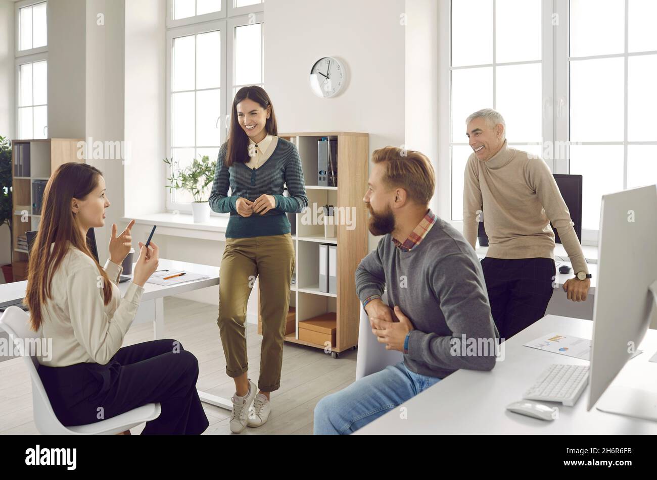 Smiling diverse people involved in team discussion Stock Photo