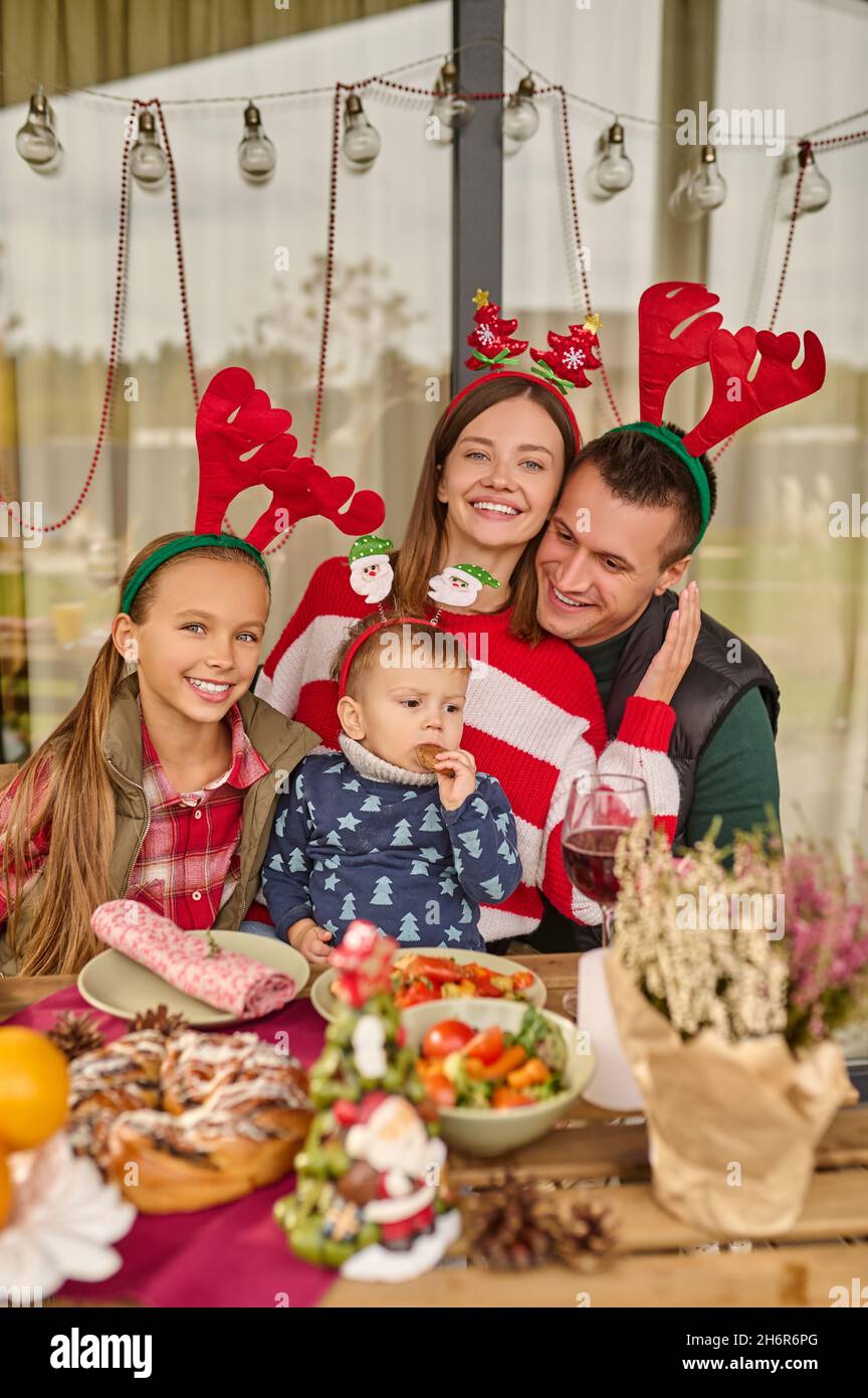 A young family celebrating christmas in the country house Stock Photo