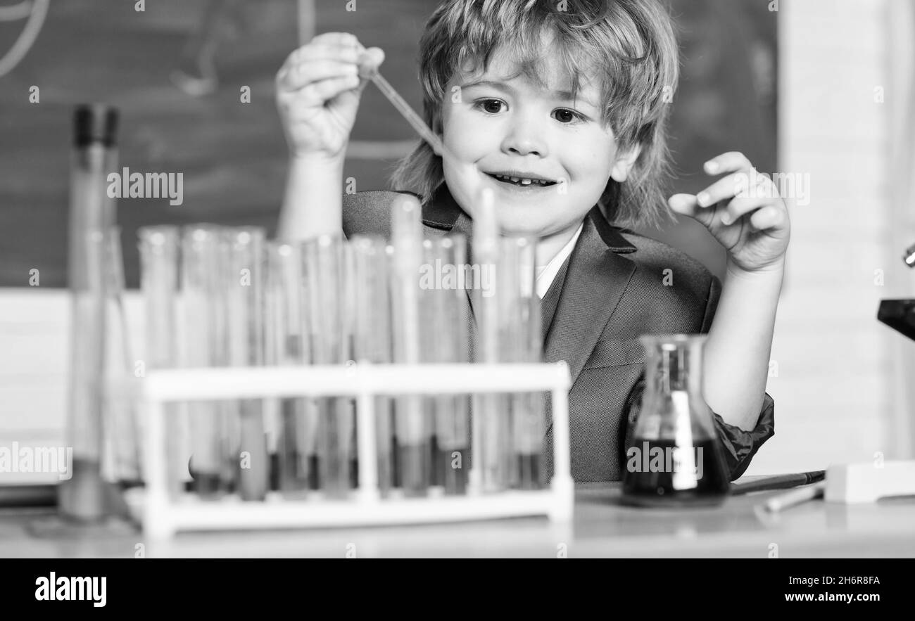 Little boy at elementary school. Biology school laboratory equipment
