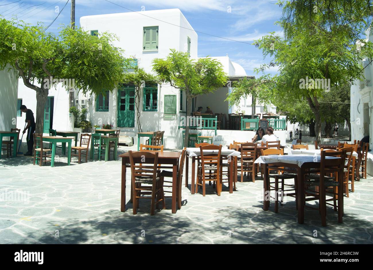 Folegandros island - Greece -  May 5 2012 : Beautiful secluded square with traditional Greek tavernas.  Typical village scene in the heart of the old Stock Photo
