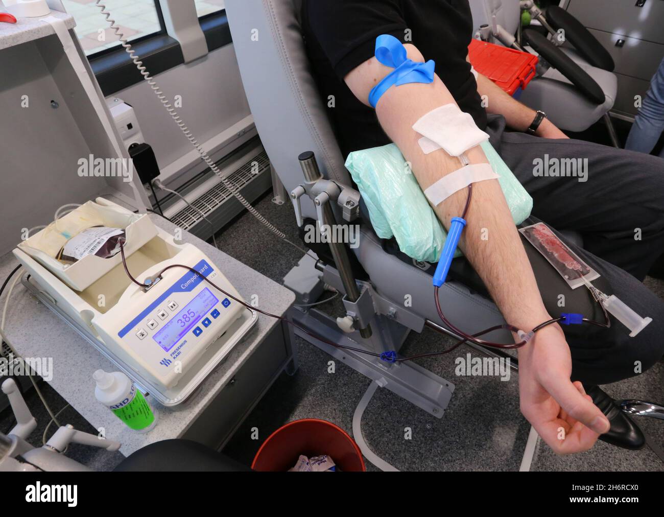 Cracow. Krakow. Poland. Arm of the blood donor with needle stuck in the vein and blood going by plastic tubes to a bag resting on the blood collection Stock Photo