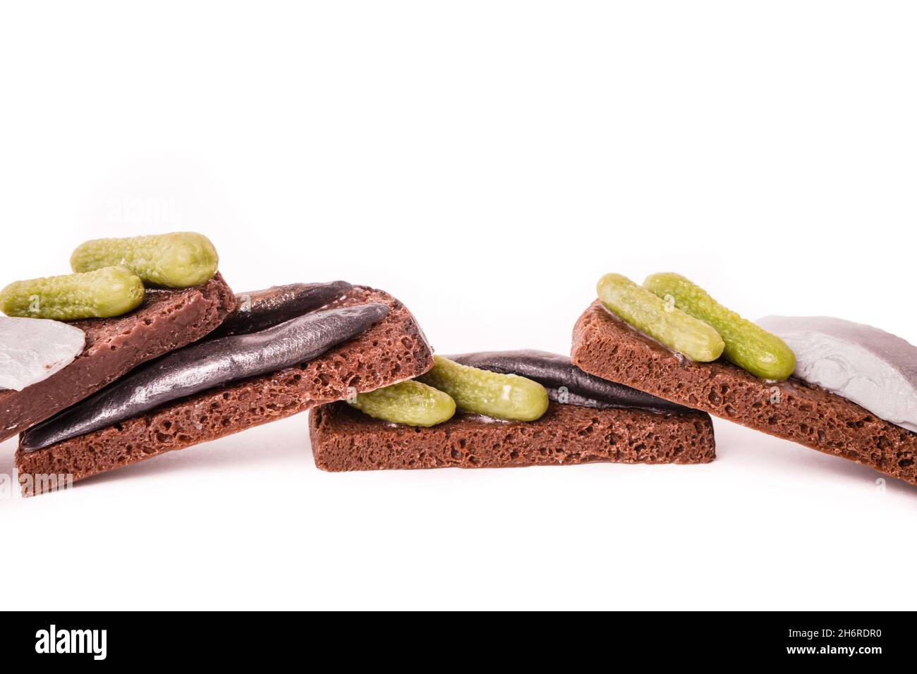 Sandwich with fish and lightly salted cucumbers on black bread.  Stock Photo