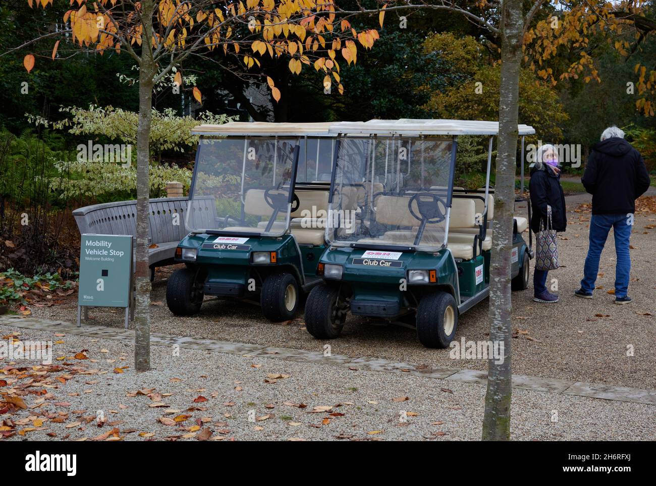 Couple seen waiting near mobility vehicles at RHS Wisley Stock Photo